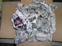 Wadded newspaper surrounding carburetor